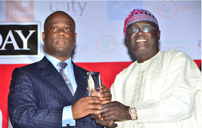 Herbert Wigwe,GMD/ CEO , Access Bank Plc being presented with the CEO of the year award by Femi Pedro, who represented Akinwunmi Ambode, Lagos State Governor